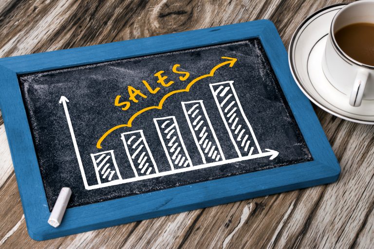 sales graph concept hand drawing on blackboard