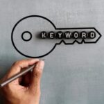 Text KEYWORD and drawing image of key. Search engine optimization, web search concept.