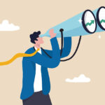 businessman financial professional look through binocular to see graph and chart.