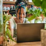 Credit card, laptop or black woman on online shopping for flowers or plants with digital money. Payment, girl or happy entrepreneur buying floral products for agro small business on ecommerce website.