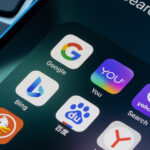 Assorted search engine apps including Google, You.com and Bing are seen on an iPhone. Microsoft plans to use ChatGPT in Bing, and You.com has launched an AI chatbot.