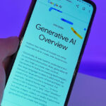 Photo of a mobile device in mans hand with generative google AI Overview on the screen.