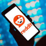 In this photo illustration, the Reddit logo is displayed on a smartphone screen.